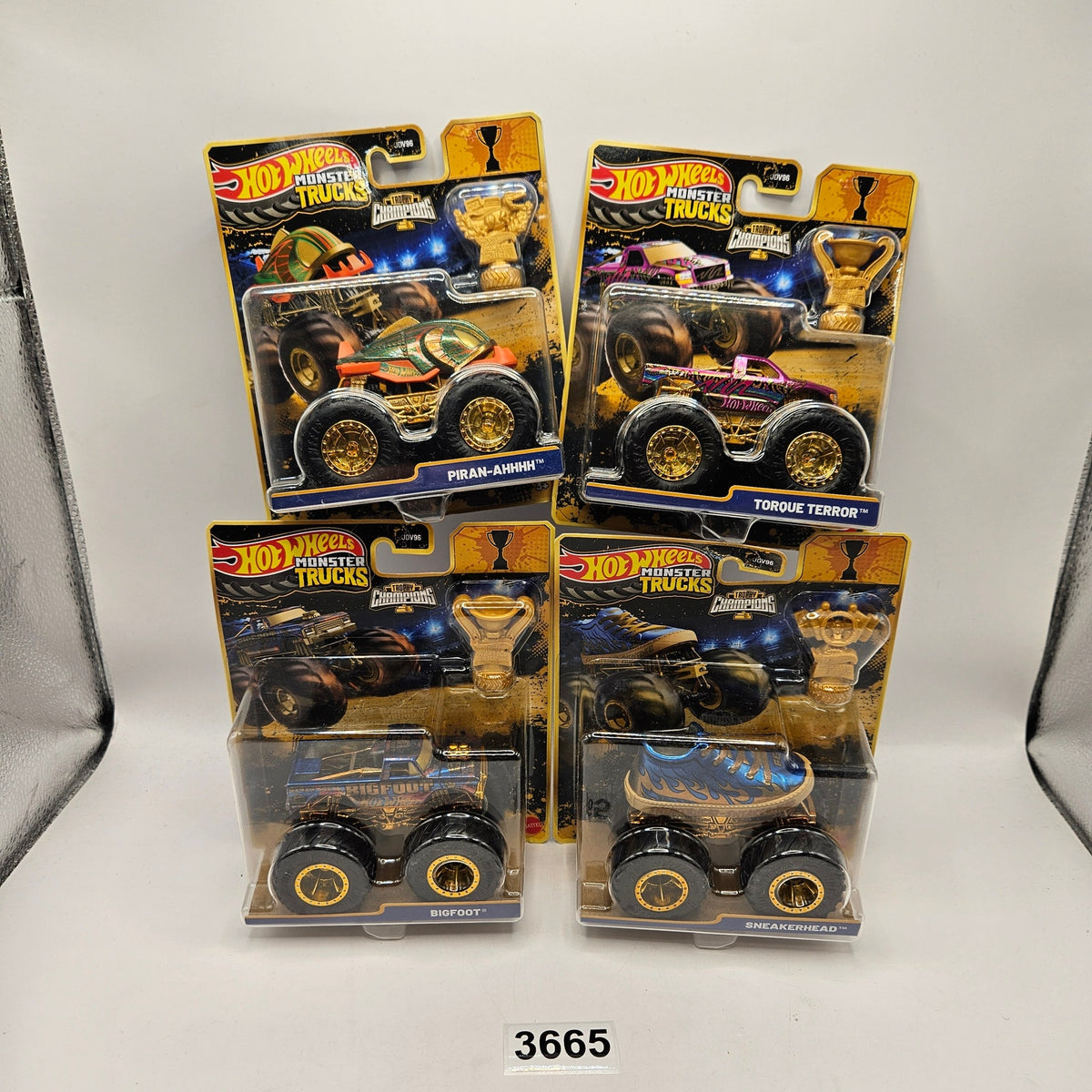 HOT WHEELS MONSTER TRUCKS TROPHY CHAMPIONS GOLD SERIES LOT OF 4 BIG FOOT SNEAKER