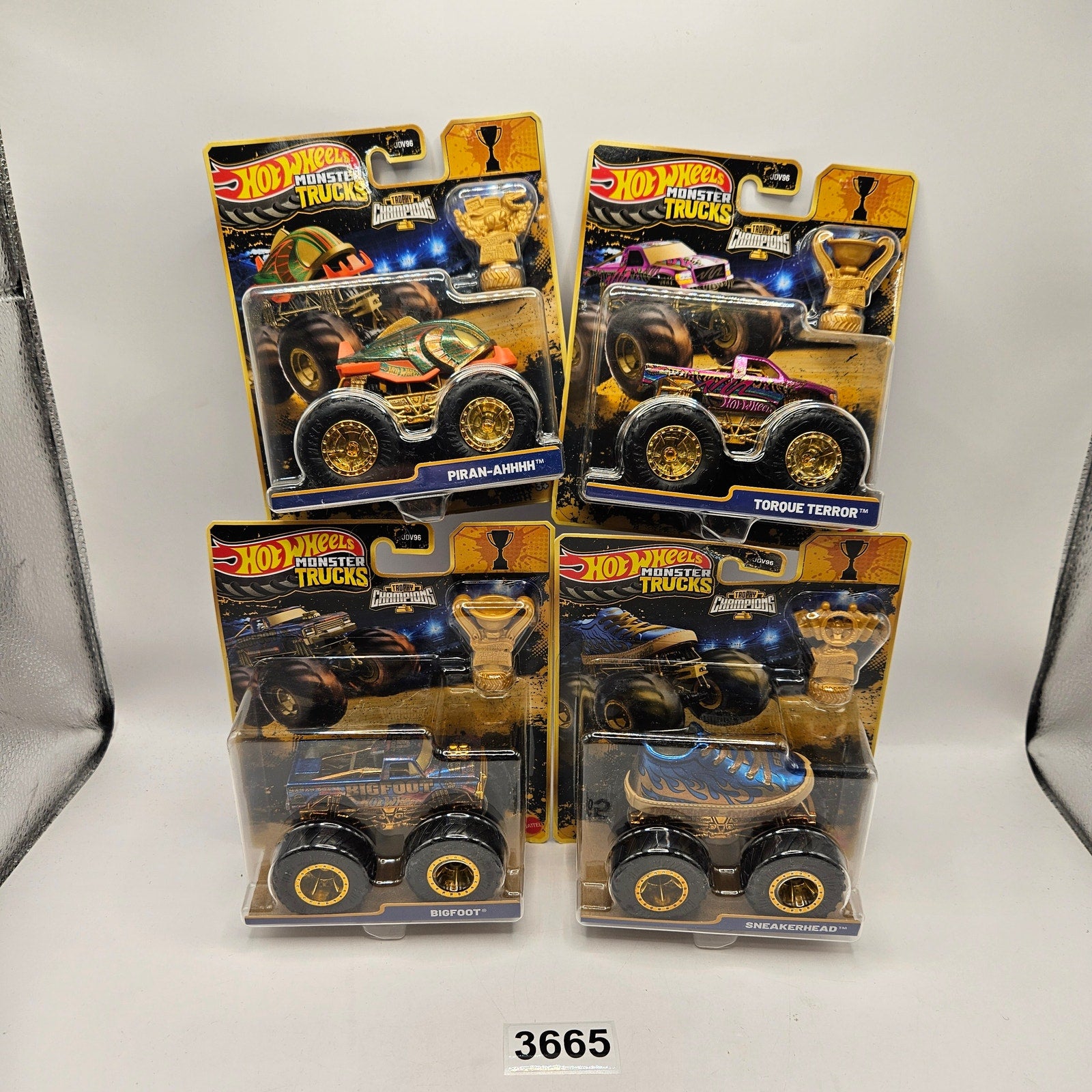 HOT WHEELS MONSTER TRUCKS TROPHY CHAMPIONS GOLD SERIES LOT OF 4 BIG FOOT SNEAKER